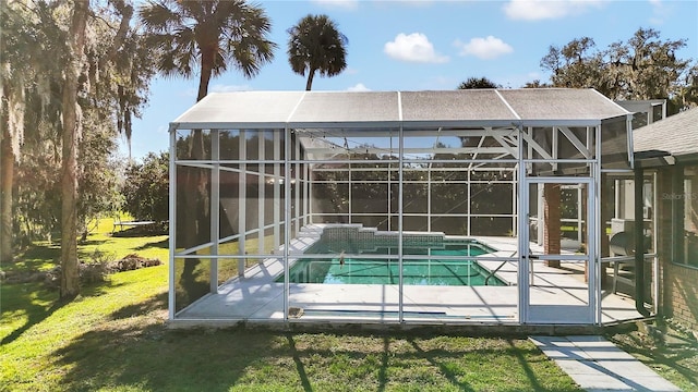 exterior space with a lanai, a lawn, and a patio area