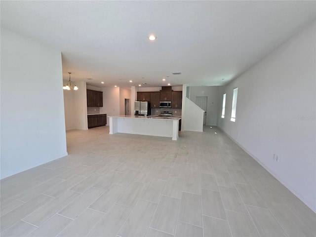 unfurnished living room featuring an inviting chandelier