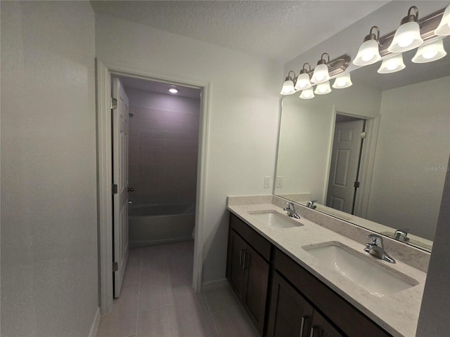 bathroom featuring vanity, a textured ceiling, and shower / bathing tub combination