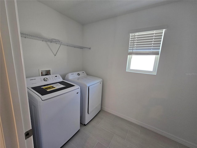 laundry area featuring separate washer and dryer and light tile patterned floors