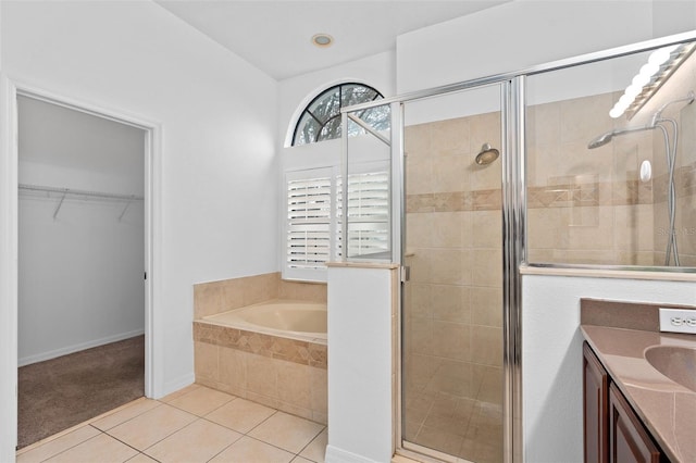 bathroom featuring vanity, shower with separate bathtub, and tile patterned flooring