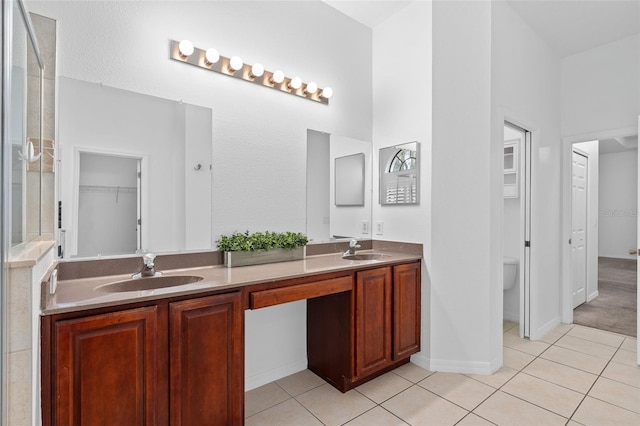 bathroom featuring tile patterned floors, toilet, and vanity