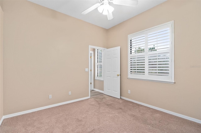 empty room featuring light carpet and ceiling fan