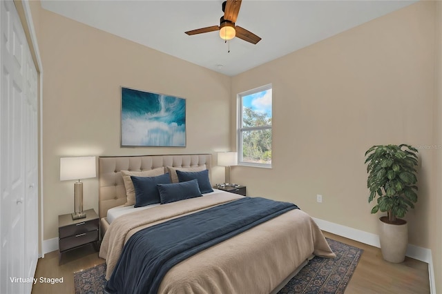 bedroom featuring light hardwood / wood-style floors, ceiling fan, and a closet