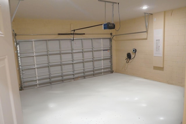 garage with a garage door opener and electric panel