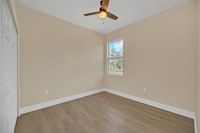 empty room with ceiling fan and light wood-type flooring