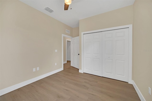 unfurnished bedroom with a closet, ceiling fan, and light wood-type flooring