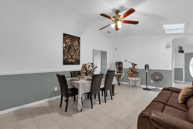 dining area with lofted ceiling with skylight and ceiling fan