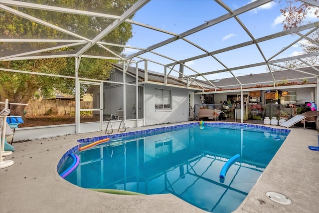 view of swimming pool featuring a patio and glass enclosure