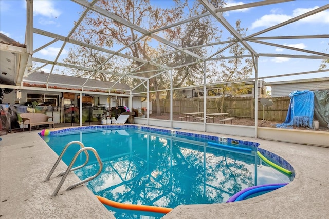 view of pool with a patio area and glass enclosure