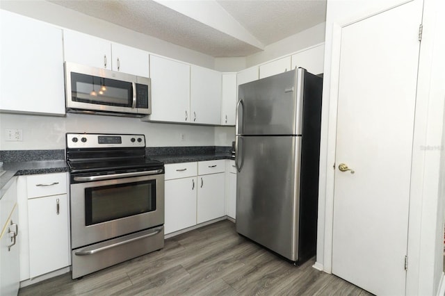 kitchen with stainless steel appliances, dark hardwood / wood-style flooring, a textured ceiling, and white cabinets