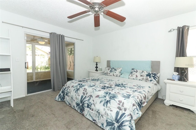 bedroom featuring ceiling fan, carpet flooring, a textured ceiling, and access to outside