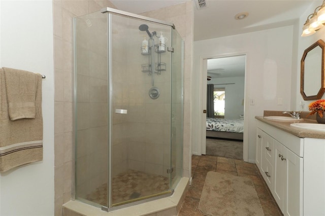 bathroom featuring an enclosed shower and vanity