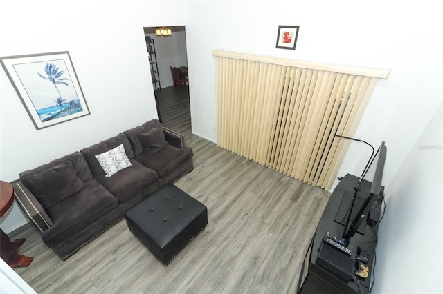 living room featuring wood-type flooring and a notable chandelier