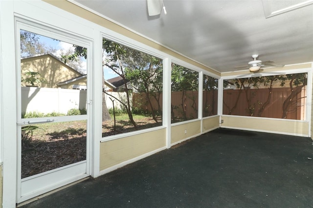 unfurnished sunroom featuring ceiling fan