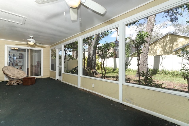 unfurnished sunroom with ceiling fan