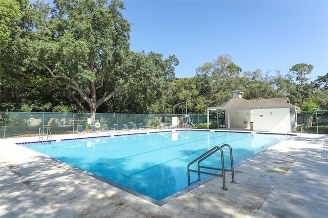 view of swimming pool with a patio