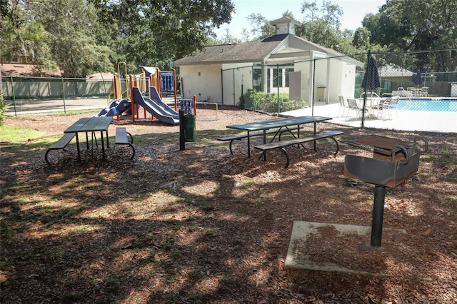 view of play area with a fenced in pool