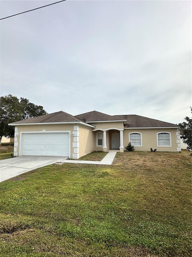 view of front of home featuring a garage and a front lawn