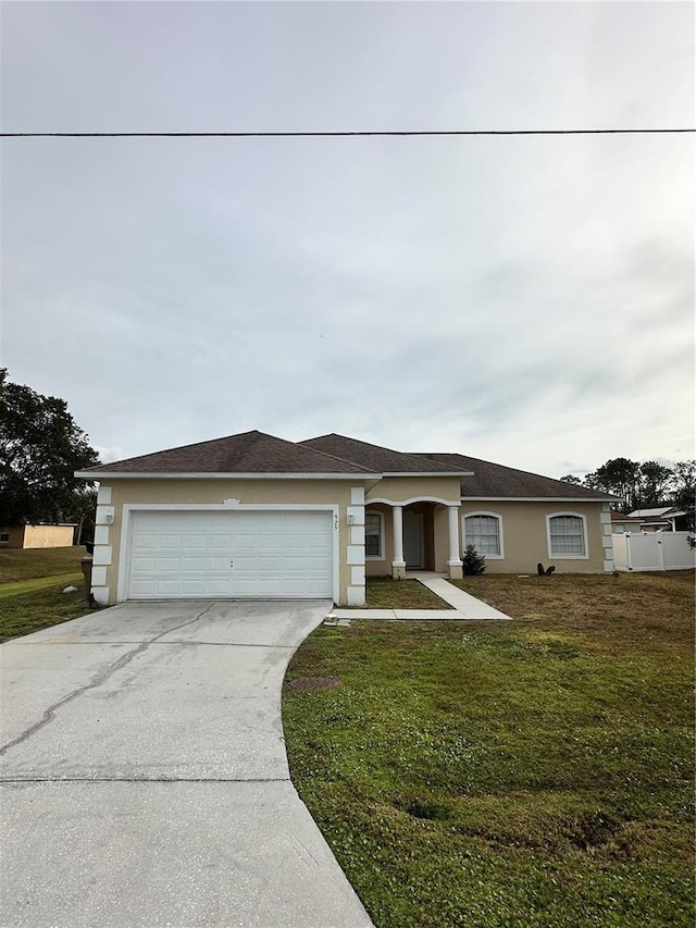 view of front of property featuring a garage and a front lawn