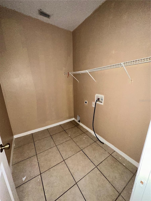 laundry area with tile patterned floors, washer hookup, and electric dryer hookup