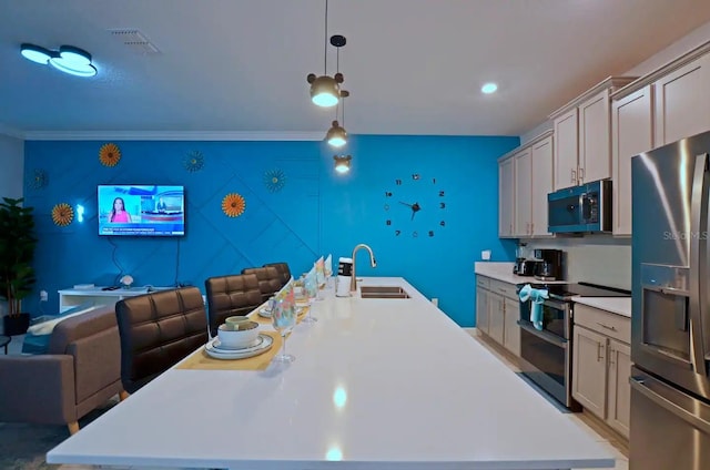 kitchen featuring appliances with stainless steel finishes, decorative light fixtures, sink, crown molding, and a center island with sink