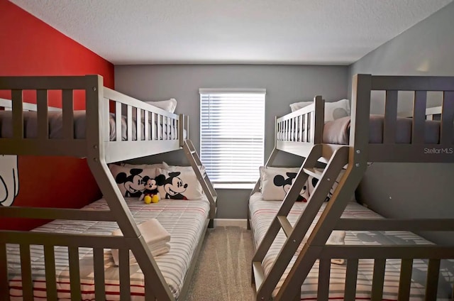 carpeted bedroom with a textured ceiling