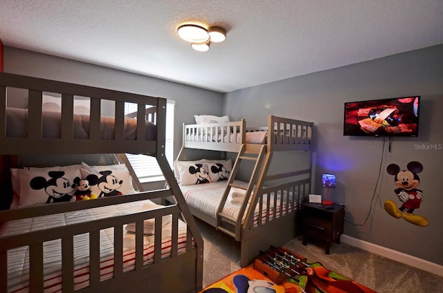 bedroom featuring carpet and a textured ceiling