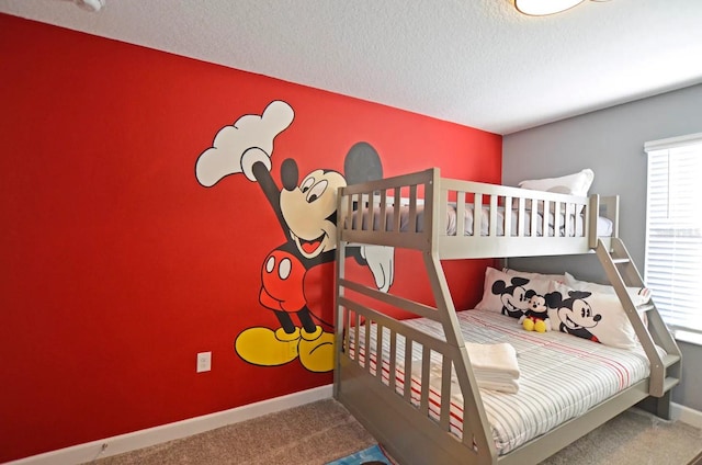 carpeted bedroom featuring a textured ceiling