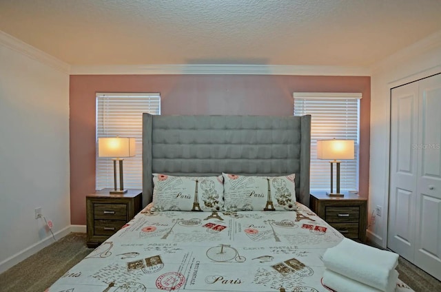 bedroom with ornamental molding, a closet, a textured ceiling, and carpet flooring