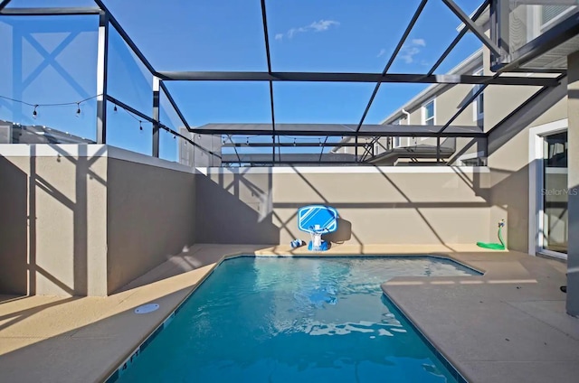 view of pool featuring a patio and glass enclosure