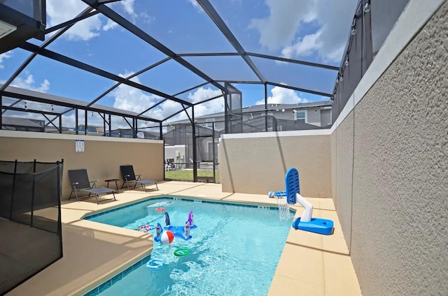 view of pool featuring a patio and glass enclosure