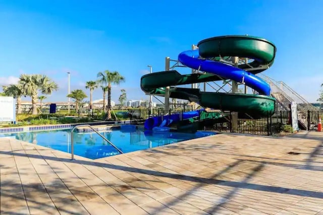 view of pool with a water slide