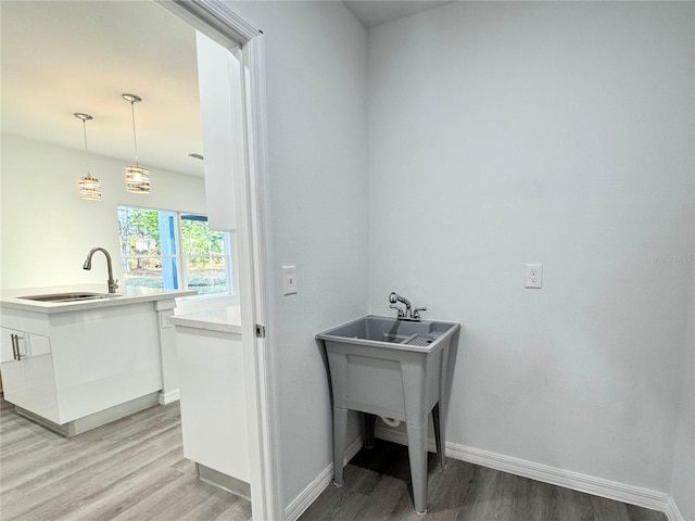 laundry room with sink and light wood-type flooring