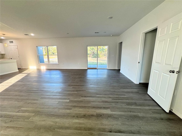 interior space with a healthy amount of sunlight and dark hardwood / wood-style flooring