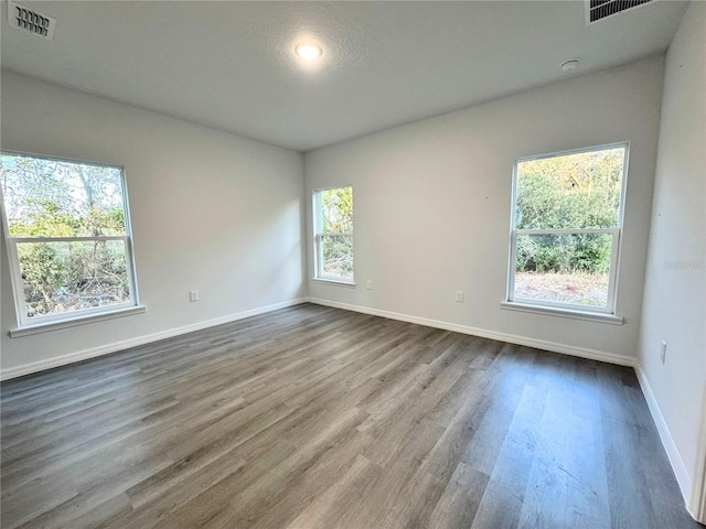 unfurnished room featuring hardwood / wood-style flooring