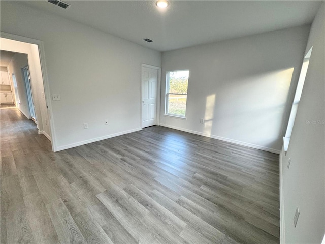 empty room with hardwood / wood-style floors