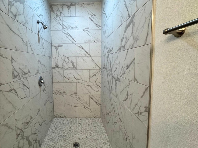 bathroom with tiled shower