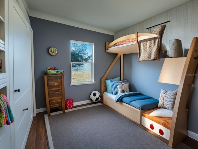 bedroom with crown molding and dark wood-type flooring