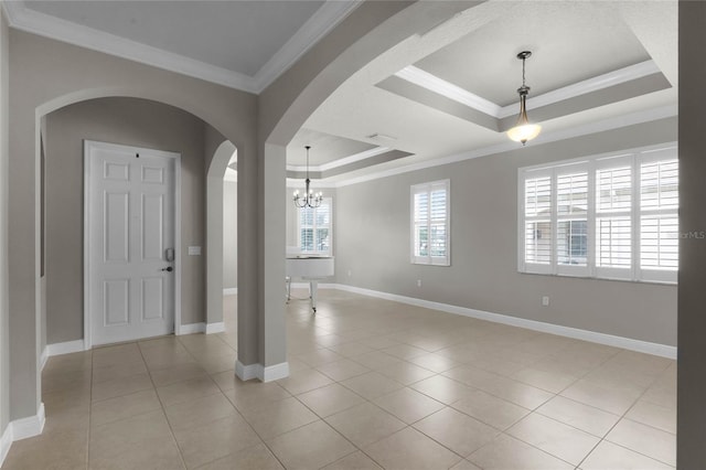 interior space with crown molding and a tray ceiling