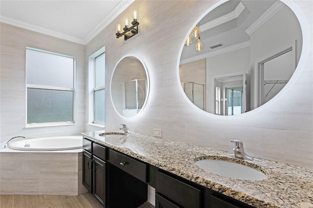 bathroom with tile walls, vanity, wood-type flooring, ornamental molding, and shower with separate bathtub