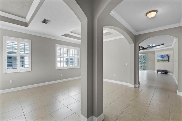 tiled spare room featuring a raised ceiling, crown molding, coffered ceiling, and a textured ceiling