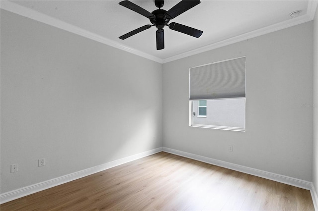 spare room with crown molding, wood-type flooring, and ceiling fan