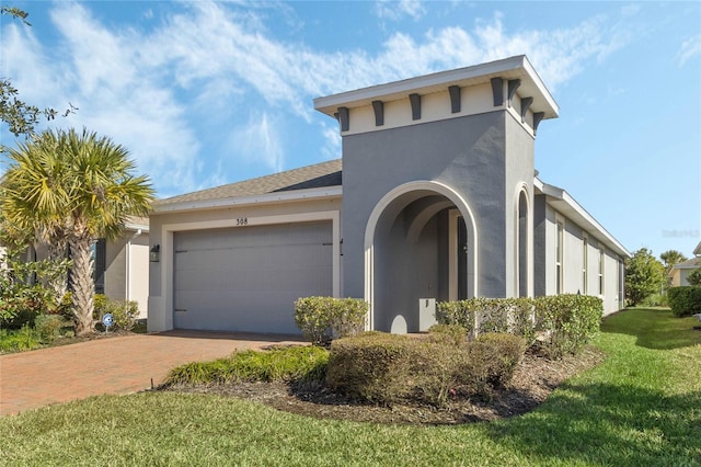 view of front of property with a garage and a front yard