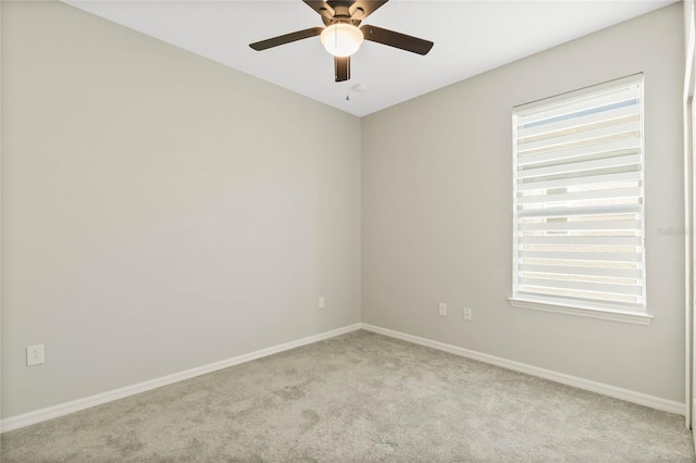 empty room featuring a healthy amount of sunlight, light colored carpet, and ceiling fan