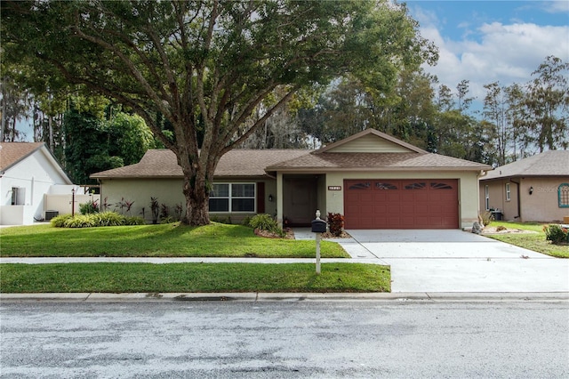 ranch-style home with a garage and a front lawn