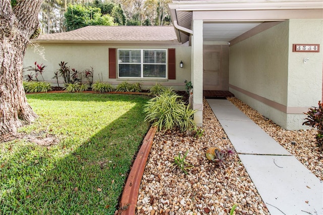 doorway to property featuring a lawn