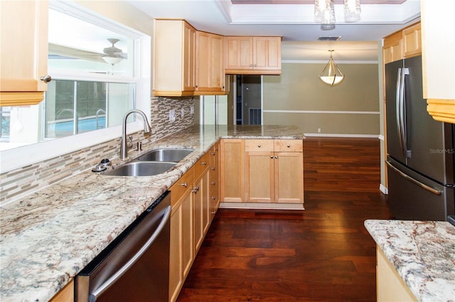 kitchen featuring sink, hanging light fixtures, light brown cabinets, dark hardwood / wood-style floors, and stainless steel appliances