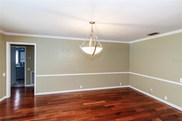 unfurnished room featuring dark wood-type flooring and ornamental molding