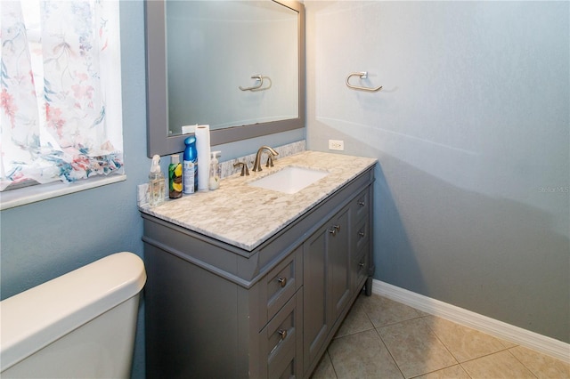 bathroom featuring vanity, tile patterned floors, and toilet